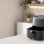 basket air fryer on a clear counter with a clean basket