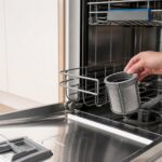 open dishwasher with clean removable filter and lower rack pulled out
